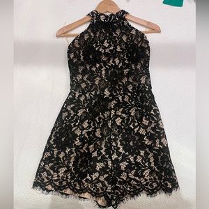 NWT black lace with nude lined halter romper. Size medium